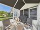 Comfortable screened-in porch with outdoor dining and grill, perfect for enjoying the fresh air and outdoor cooking at 21707 Queen Mary Ct, Leesburg, FL 34748