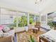 Inviting sunroom with lots of natural light and view of the backyard, with comfortable seating and warm rug at 21707 Queen Mary Ct, Leesburg, FL 34748