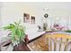 Cozy sunroom featuring natural light, comfortable seating, hardwood floors, and views into the living area at 21707 Queen Mary Ct, Leesburg, FL 34748