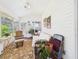 Bright sunroom with large windows, chair and futon; a perfect spot for relaxation and enjoying natural light at 21707 Queen Mary Ct, Leesburg, FL 34748
