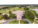 Aerial view of the building with putting greens and fairway off in the distance at 21815 Tartan St, Leesburg, FL 34748