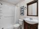 Bathroom featuring a shower, toilet, and a vanity with a dark wood cabinet at 21815 Tartan St, Leesburg, FL 34748