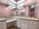 Bathroom featuring a skylight, a vanity with ample counter space, and a large mirror at 21815 Tartan St, Leesburg, FL 34748