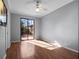 Empty bedroom featuring wood floors and sliding glass doors leading to an outdoor patio at 21815 Tartan St, Leesburg, FL 34748
