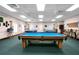Bright billiards room with multiple pool tables, seating, and ample space for players at 21815 Tartan St, Leesburg, FL 34748
