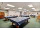 Well-lit billiards room featuring multiple tables and seating for enjoyable recreational activities at 21815 Tartan St, Leesburg, FL 34748