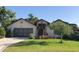 Charming single-story home with a well-manicured lawn and inviting front entrance at 21815 Tartan St, Leesburg, FL 34748