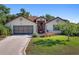 Charming single-story home with a well-manicured lawn and inviting front entrance at 21815 Tartan St, Leesburg, FL 34748