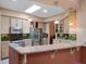 Well-lit kitchen with stainless steel appliances and counter seating under a skylight at 21815 Tartan St, Leesburg, FL 34748