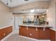 Kitchen featuring modern appliances, tile flooring, and an open layout with countertop seating at 21815 Tartan St, Leesburg, FL 34748