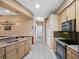Kitchen featuring light wood cabinets and stainless appliances at 21815 Tartan St, Leesburg, FL 34748