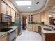 Spacious kitchen with stainless steel appliances, tile flooring, and ample cabinet space at 21815 Tartan St, Leesburg, FL 34748