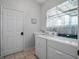 Laundry room with washer, dryer, utility sink, and ample storage space at 21815 Tartan St, Leesburg, FL 34748