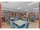 A spacious library with floor-to-ceiling shelves filled with books, and tables with seating at 21815 Tartan St, Leesburg, FL 34748