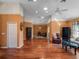 Spacious living room with hardwood floors, neutral walls, ceiling fan, and ample space for entertaining at 21815 Tartan St, Leesburg, FL 34748