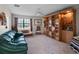 Bright living room featuring a built-in bookcase and large window that provides ample natural light at 21815 Tartan St, Leesburg, FL 34748