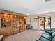 Cozy living room with built-in bookcase and sliding glass door to the backyard patio at 21815 Tartan St, Leesburg, FL 34748