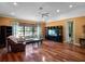Bright living room with hardwood floors, large window, and a ceiling fan at 21815 Tartan St, Leesburg, FL 34748