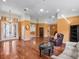 Expansive living room featuring hardwood floors and views into other rooms at 21815 Tartan St, Leesburg, FL 34748