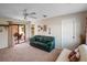 Neutral living room with sliding glass doors to the patio and a ceiling fan at 21815 Tartan St, Leesburg, FL 34748