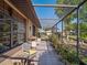 Relaxing screened patio with outdoor seating and views of the surrounding garden at 21815 Tartan St, Leesburg, FL 34748