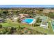 Aerial view of the community pool and tennis courts on a bright and sunny day at 21815 Tartan St, Leesburg, FL 34748
