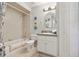 Compact bathroom featuring a tub-shower combo, toilet, and vanity area at 236 Juniper Way, Tavares, FL 32778