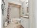 Cozy bathroom featuring a shower-tub combo, white vanity with solid surface countertop, and neutral colored tile flooring at 236 Juniper Way, Tavares, FL 32778