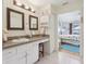 Bright bathroom featuring a vanity with cabinets and a view into the bedroom at 236 Juniper Way, Tavares, FL 32778