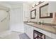 Bathroom with vanity, dual mirrors, shower, and neutral color scheme at 236 Juniper Way, Tavares, FL 32778