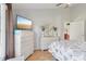 Bedroom view with TV, dresser, and open doorway, creating an airy feel at 236 Juniper Way, Tavares, FL 32778