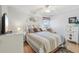 Inviting bedroom with ceiling fan, comfortable bed, and chest of drawers at 236 Juniper Way, Tavares, FL 32778