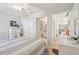 Bedroom showcasing an open layout with bathroom and hallway access at 236 Juniper Way, Tavares, FL 32778