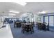 Spacious dining area features neutral walls, carpet, and a table with seating for community gatherings and events at 236 Juniper Way, Tavares, FL 32778