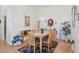 Dining room features wood floors, chandelier, and table set for six at 236 Juniper Way, Tavares, FL 32778