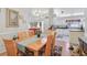 Open-concept dining area flows into a well-lit kitchen and living space at 236 Juniper Way, Tavares, FL 32778