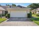 Attached garage with a clean, well-maintained door and concrete driveway at 236 Juniper Way, Tavares, FL 32778