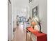 Bright hallway with wood floors, leading to open-concept living spaces and featuring decorative accents and contemporary decor at 236 Juniper Way, Tavares, FL 32778