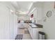 Well-lit kitchen with white cabinets, tile flooring, and modern appliances providing a clean and efficient cooking area at 236 Juniper Way, Tavares, FL 32778