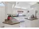 Bright kitchen with white cabinets, granite countertops, and modern appliances offers a functional and stylish cooking space at 236 Juniper Way, Tavares, FL 32778