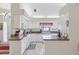 Bright kitchen with white cabinets, granite countertops, and modern appliances offers a functional and stylish cooking space at 236 Juniper Way, Tavares, FL 32778