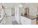 Open kitchen featuring a granite countertop island, white cabinets, and modern appliances seamlessly connected to the dining area at 236 Juniper Way, Tavares, FL 32778