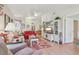 The living room showcases a vaulted ceiling, with hardwood floors and TV at 236 Juniper Way, Tavares, FL 32778