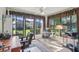 Sunroom with a ceiling fan, curtains, desk, and a table with comfortable seating, perfect for relaxing at 236 Juniper Way, Tavares, FL 32778