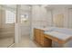 Bathroom featuring a tiled shower, vanity area, and a separate toilet room at 26207 Avenida Las Colinas # 26207, Howey In The Hills, FL 34737