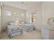 Cozy bedroom featuring twin beds, woven dressers, and natural light from windows at 26207 Avenida Las Colinas # 26207, Howey In The Hills, FL 34737
