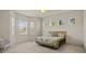 Bright bedroom with multiple windows providing natural light and a comfortable quilt-covered bed at 26207 Avenida Las Colinas # 26207, Howey In The Hills, FL 34737