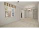 Spacious bedroom featuring a carpeted floor, chandelier, and a window providing natural light at 26207 Avenida Las Colinas # 26207, Howey In The Hills, FL 34737