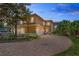Stunning two-story home featuring a circular driveway and lush landscaping at 26207 Avenida Las Colinas # 26207, Howey In The Hills, FL 34737