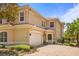 Charming two-story home with a neutral color scheme, a tile roof, brick driveway, and a manicured front yard at 26207 Avenida Las Colinas # 26207, Howey In The Hills, FL 34737